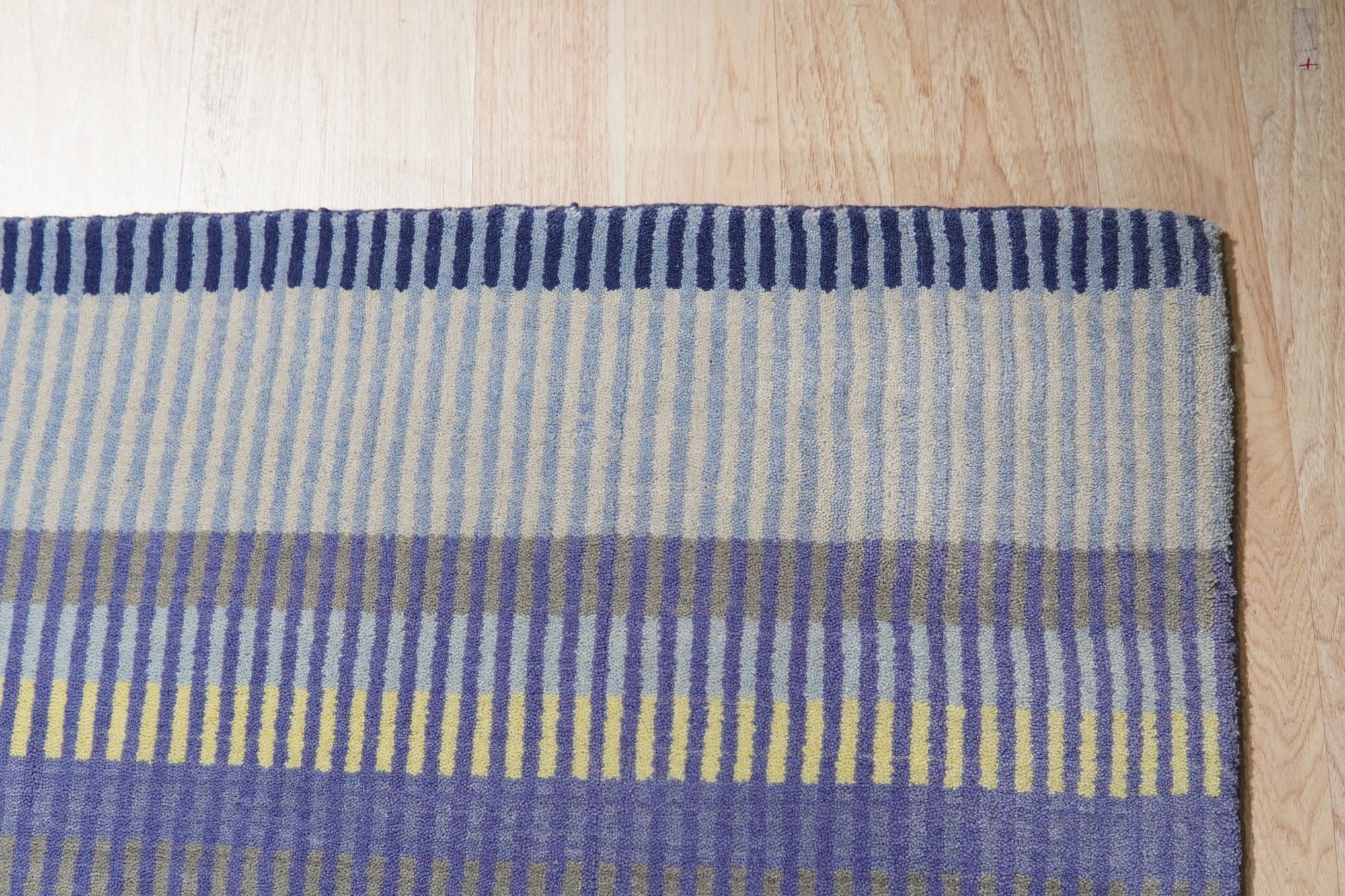 Comfortable Striped Lavender Handmade Wool Rug, soft lavender and neutral stripes create a serene and inviting texture, showcasing the handmade wool rug's cozy warmth and subtle pattern.