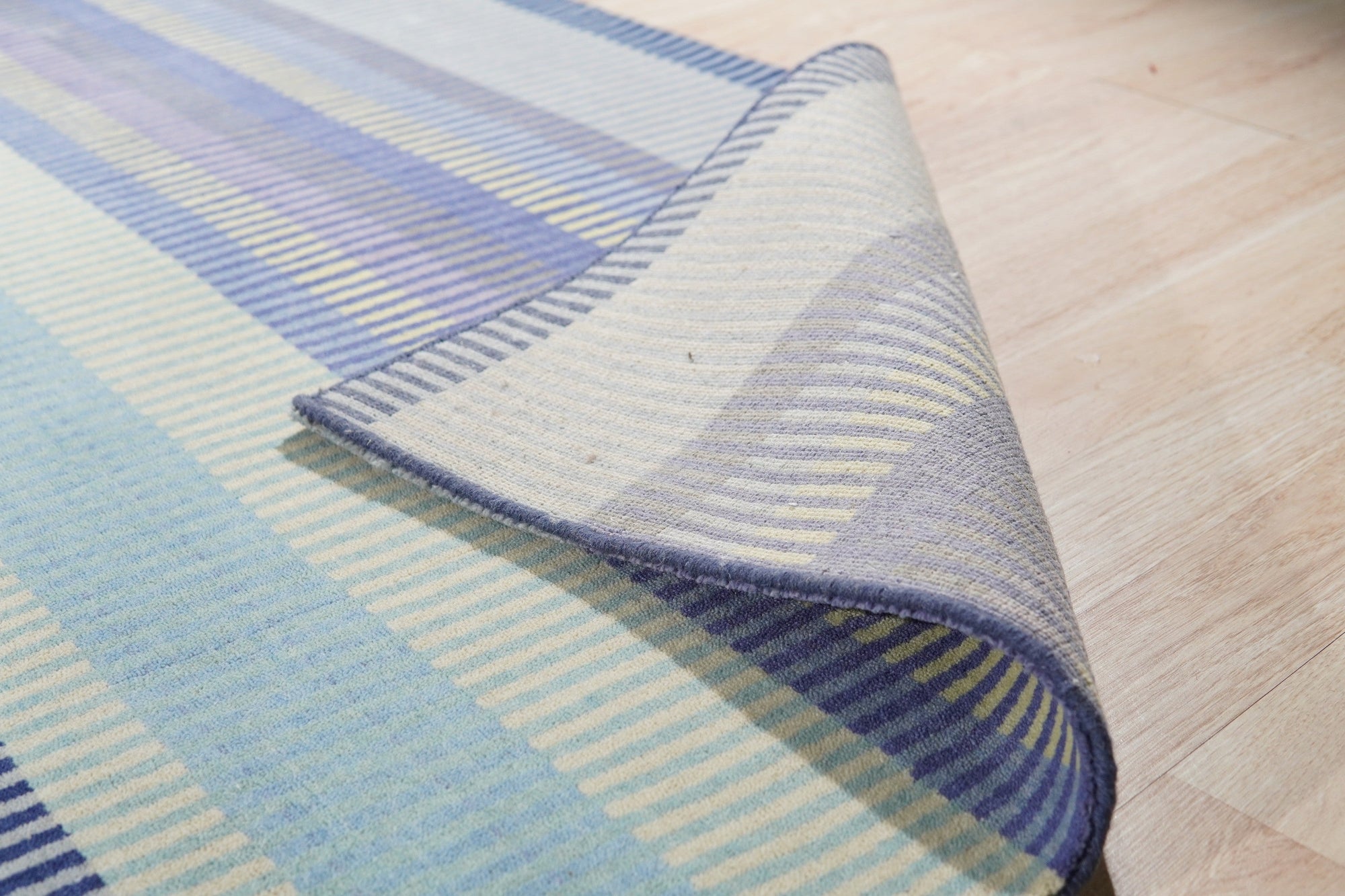Comfortable Striped Lavender Handmade Wool Rug, soft lavender and cream stripes define this cozy wool rug, adding warmth and subtle color to a modern living space.