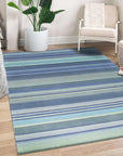 Comfortable Striped Lavender Handmade Wool Rug displayed in a well-lit living room setting; showcases the rug's soft texture and subtle lavender stripes harmonizing with neutral furniture, illustrating its potential to add warmth and style to home decor.