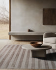 Yara Alluring Brown Handmade Wool Rug, a textured expanse of warm browns and creams under soft lighting, inviting touch. Its intricate, possibly hand-knotted, weave displays subtle pattern variations and a rich depth of color.