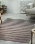 Yara Alluring Brown Handmade Wool Rug, its warm brown tones and subtle texture enriching a modern living room setting.