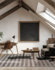 Yara Alluring Brown Handmade Wool Rug, a rich brown wool rug with subtle textural variations, displayed in a modern living room setting.