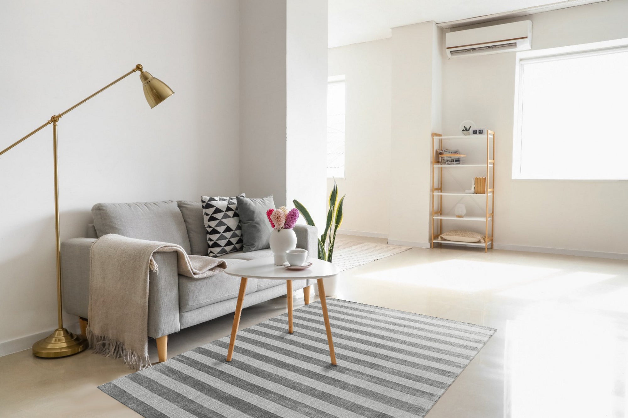 Yara Alluring Gray Handmade Wool Rug, a textured gray wool rug with subtle variations in tone, displayed in a bright, airy living room setting.