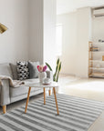 Yara Alluring Gray Handmade Wool Rug, a textured gray wool rug with subtle variations in tone, displayed in a bright, airy living room setting.