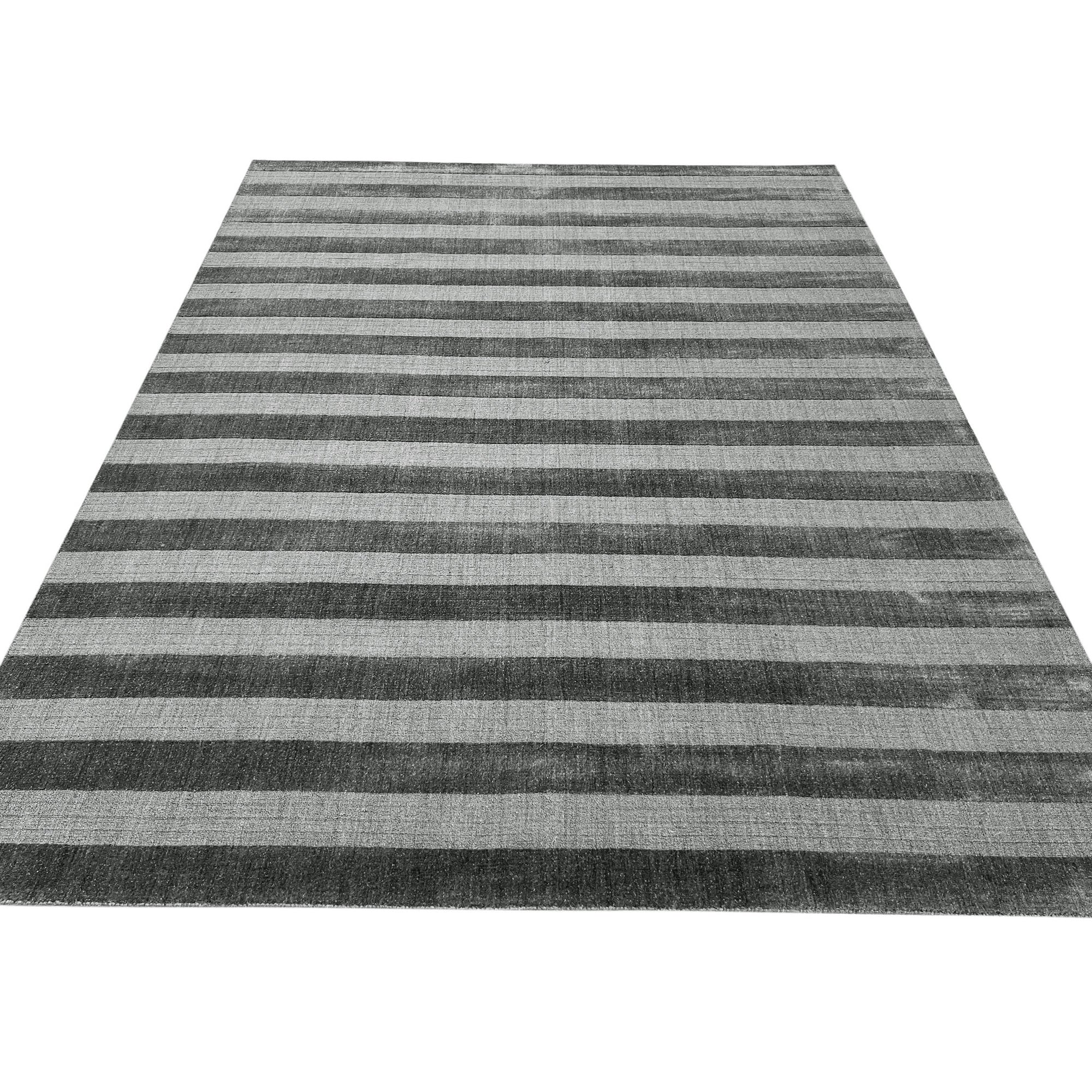 Yara Alluring Gray Handmade Wool Rug, showcasing its subtle gray tones and textured wool construction, adding a sophisticated touch to a bright, airy living space.