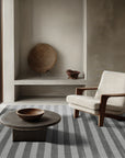 Yara Alluring Gray Handmade Wool Rug, a soft gray wool rug with subtle texture, displayed within a bright and airy living space.