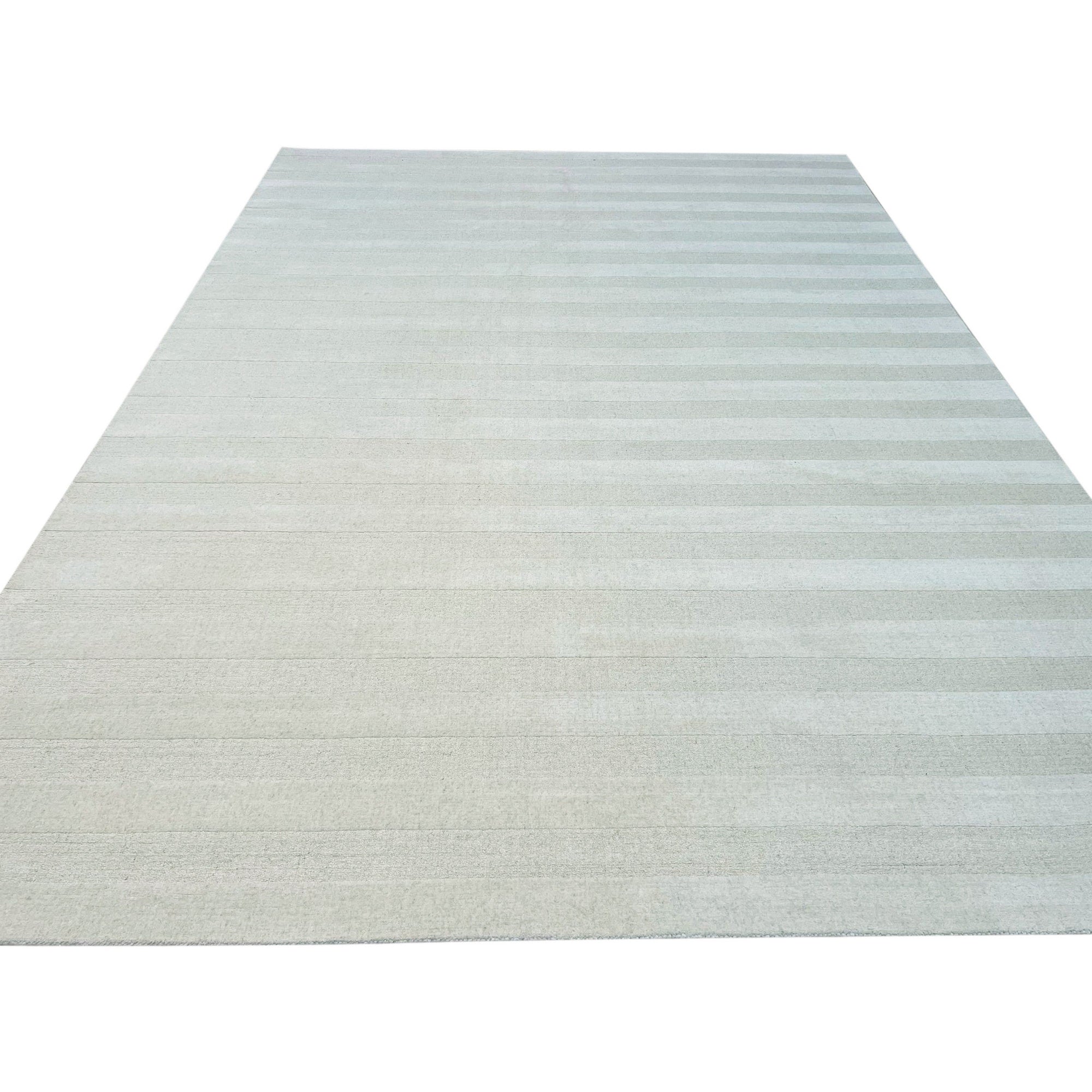 Yara Alluring Black & White Handmade Wool Rug, a striking geometric pattern in black and white wool, lies on a light hardwood floor with natural lighting.