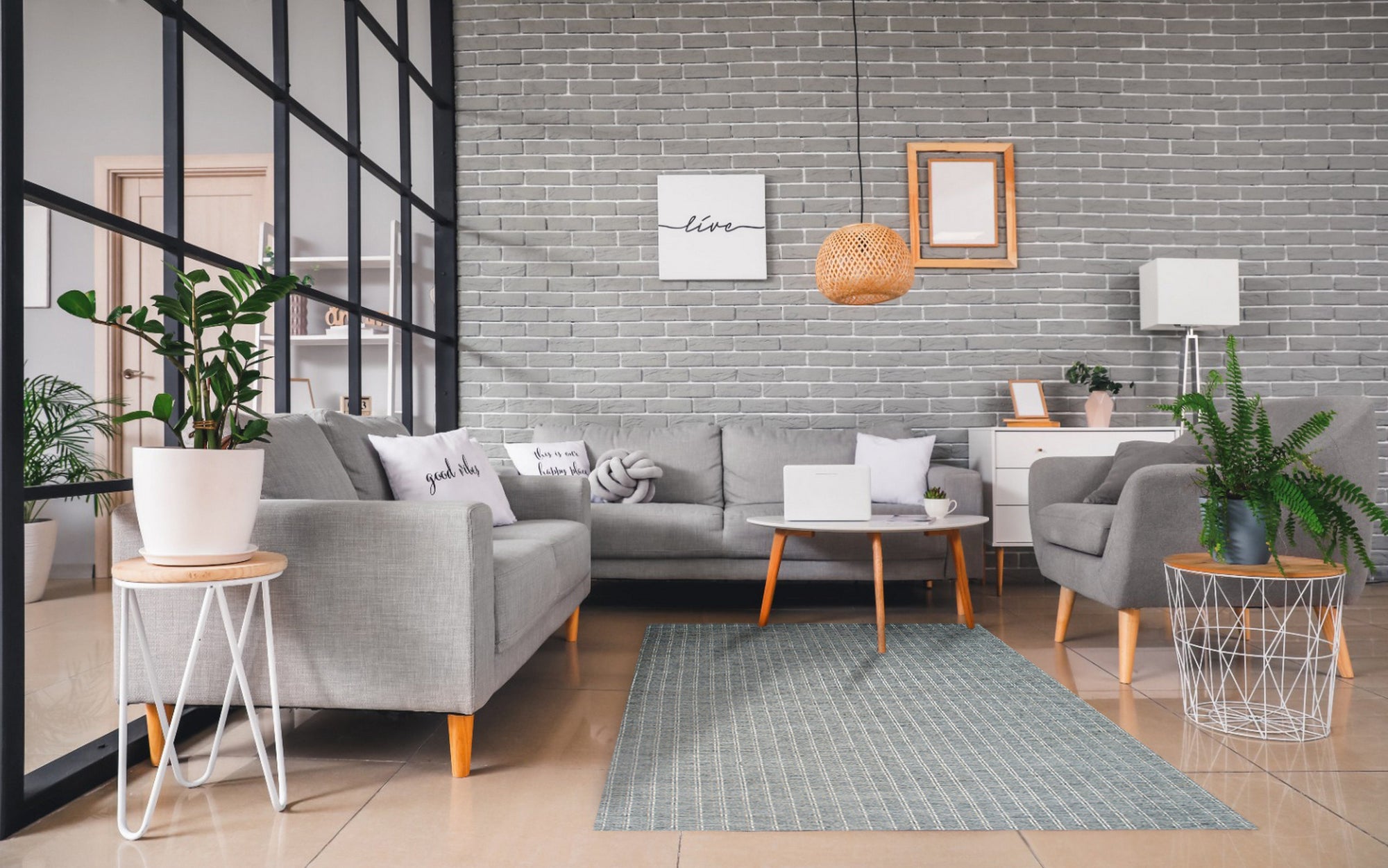 Delicate Giselle Gray Handmade Wool Rug, showcasing subtle variations in gray tones and texture in a lifestyle setting. Woven wool provides a soft, inviting surface.