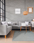 Delicate Giselle Gray Handmade Wool Rug, showcasing subtle variations in gray tones and texture in a lifestyle setting. Woven wool provides a soft, inviting surface.