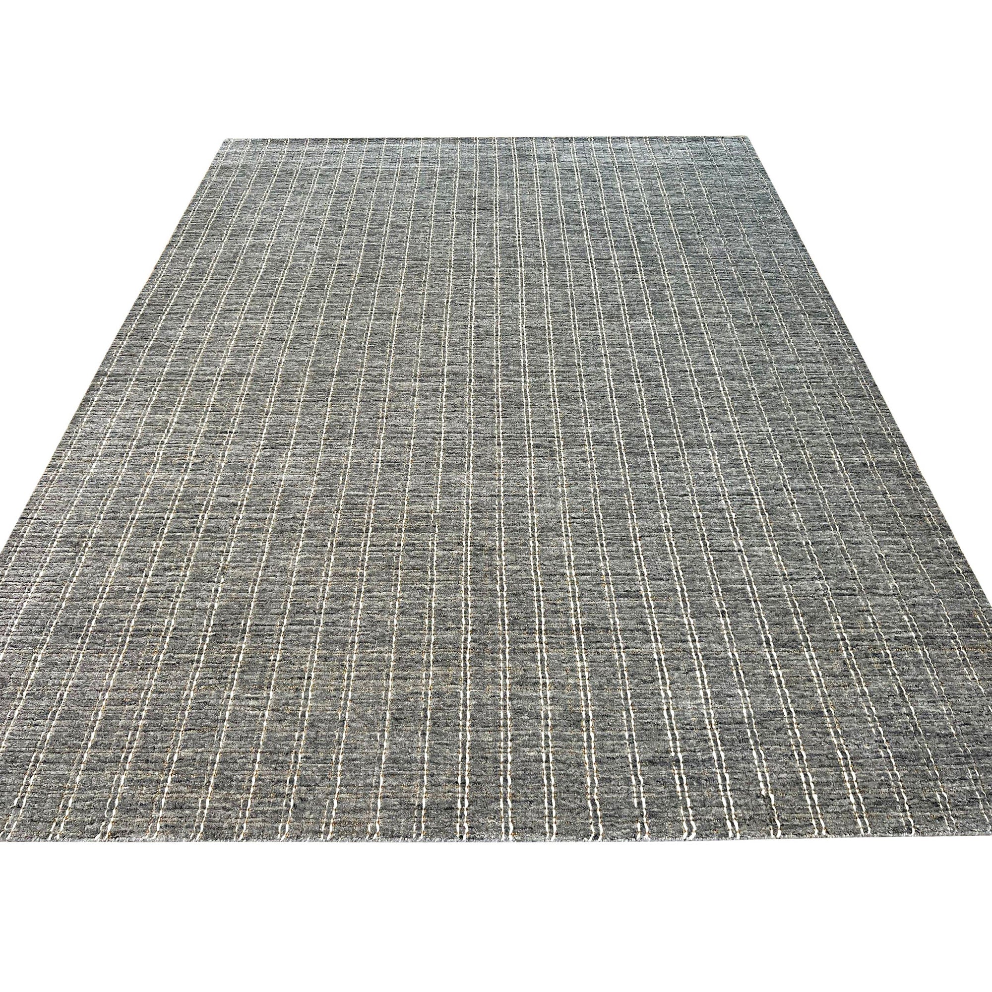 Delicate Giselle Gray Handmade Wool Rug, featuring a subtle pattern and soft texture, displayed in a bright, modern living space.