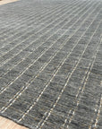 Delicate Giselle Gray Handmade Wool Rug, displaying subtle, interwoven patterns in muted grays and creams, filling the frame with its soft texture and detailed craftsmanship.