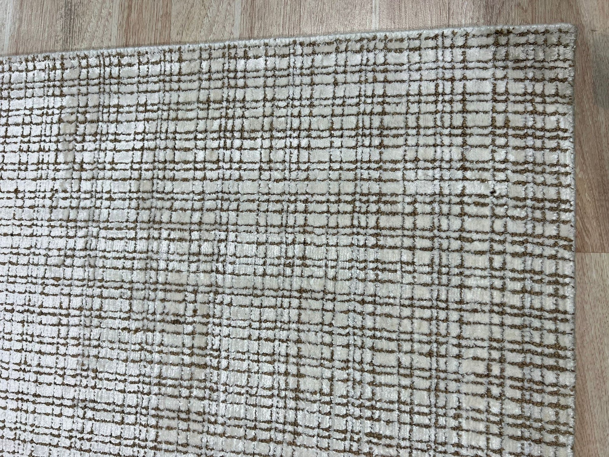 Warm Sarrah White Handmade Bamboo Silk Rug, its soft, creamy white hues and luxurious bamboo silk sheen lending an elegant touch to a modern living space.