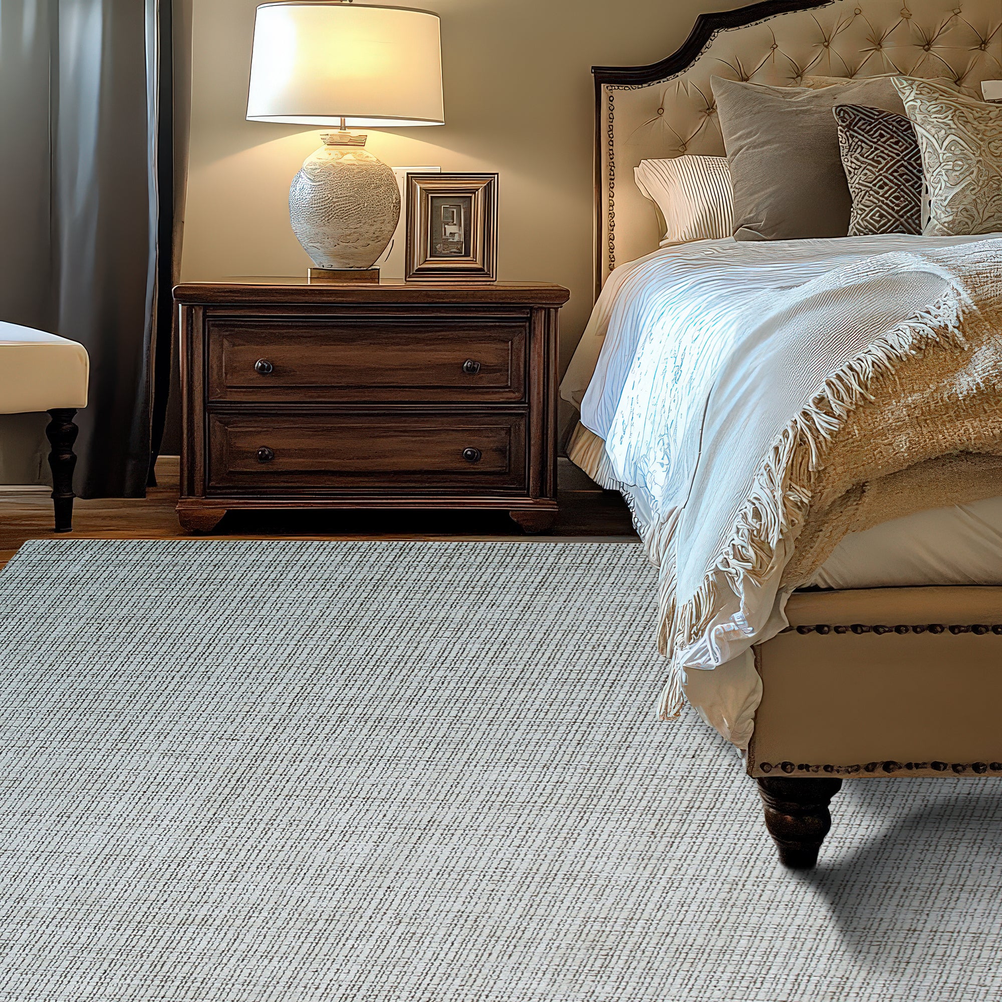 Warm Sarrah White Handmade Bamboo Silk Rug, a luminous ivory rug with subtle sheen, showcased in a bright, modern living space. Delicate variations in texture hint at the hand-knotted construction.