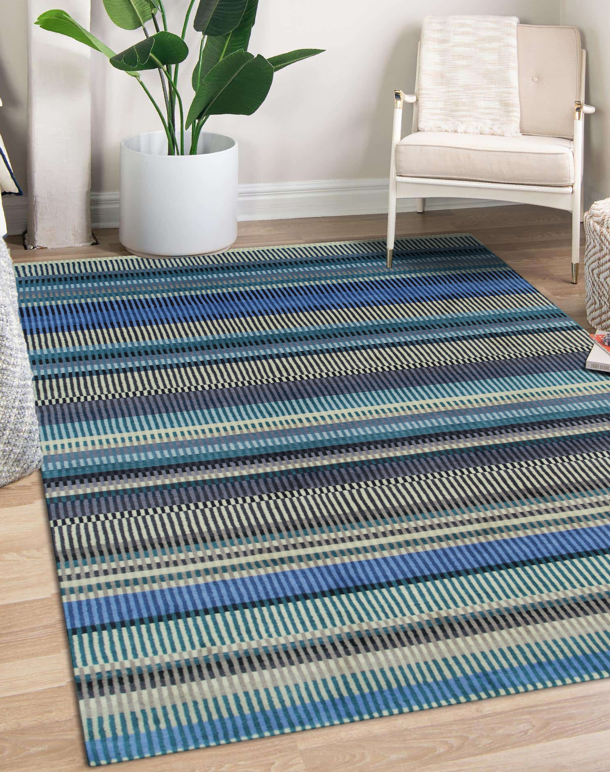 Louie Ophelia Ocean Blue Handmade Wool Rug, waves of deep ocean blue cascade across hand-knotted wool, creating a calming and textural floor covering in a warmly lit interior.