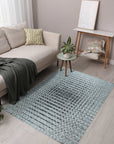 Nadia Ava Gray Handmade Wool Rug, showcasing its subtle gray tones and hand-woven wool texture in a living room setting with modern furniture.