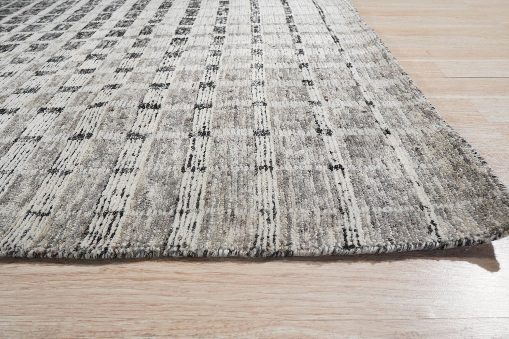 Nadia Ava Gray Handmade Wool Rug, soft gray hues and subtle texture blend seamlessly into a contemporary living room setting, highlighting its handmade wool construction.