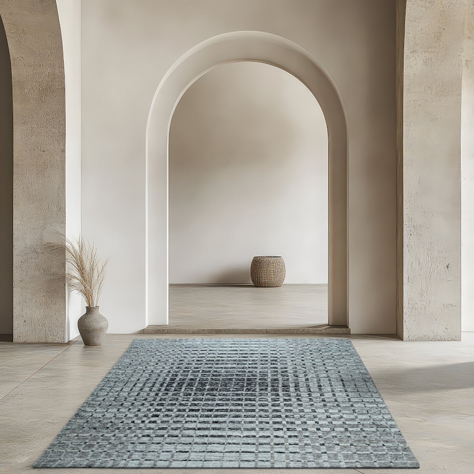 Nadia Ava Gray Handmade Wool Rug, blending subtle gray tones in a woven wool texture, partially visible beneath a light wood coffee table and modern cream-colored sofa.