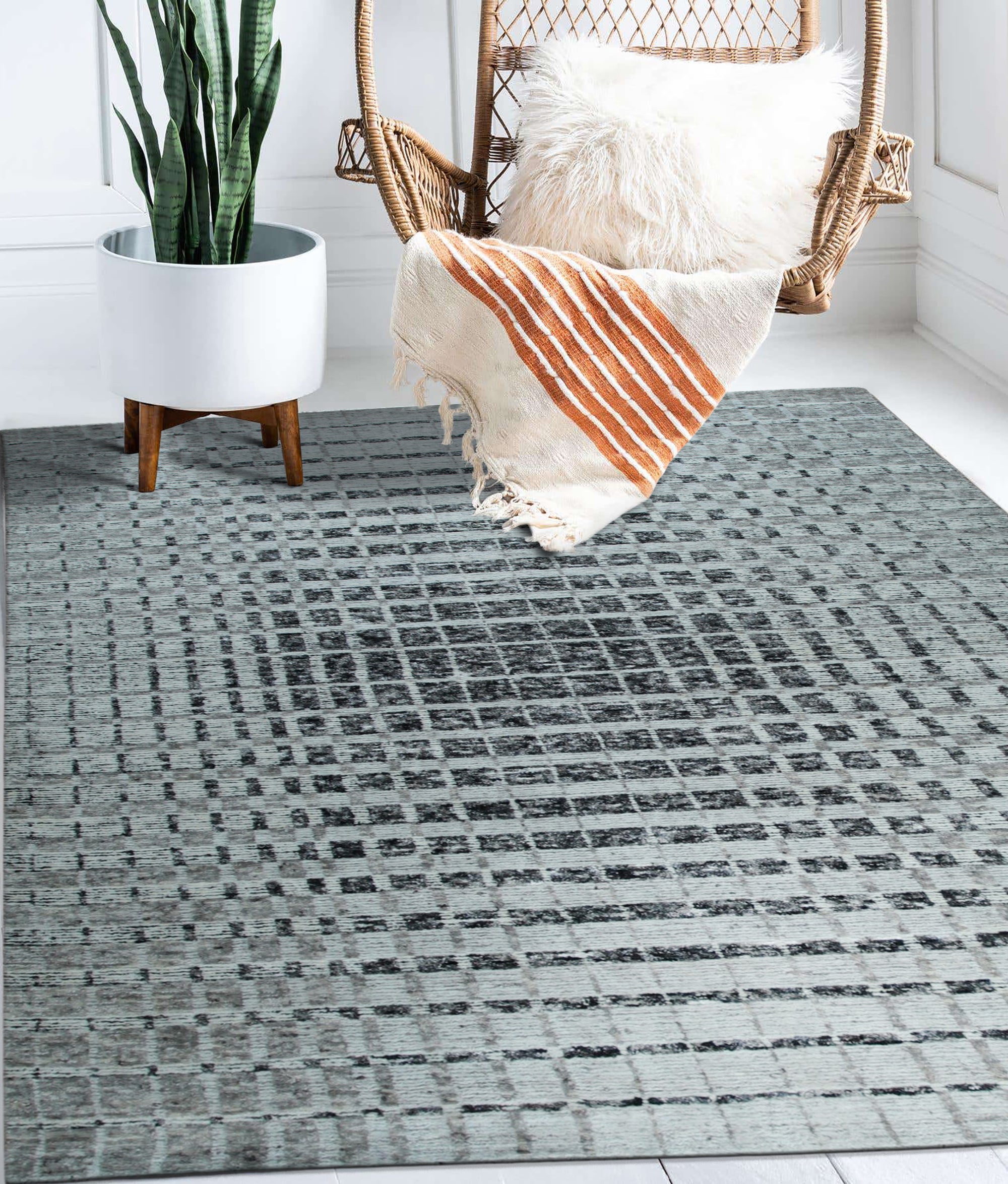 Nadia Ava Gray Handmade Wool Rug, blending soft grays in a subtle, textured design, complements a modern living room with neutral furnishings.