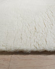 Willow Sarrah Ivory Handmade Wool Rug, showcasing soft ivory tones and a subtly textured design, elegantly positioned within a bright, modern living space.