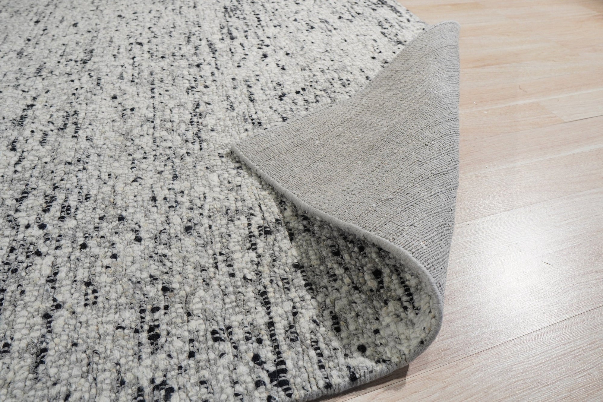 Opulent Alluring Dark Gray Handmade Wool Rug, a rich dark gray wool rug with subtle texture, grounding a contemporary living space.