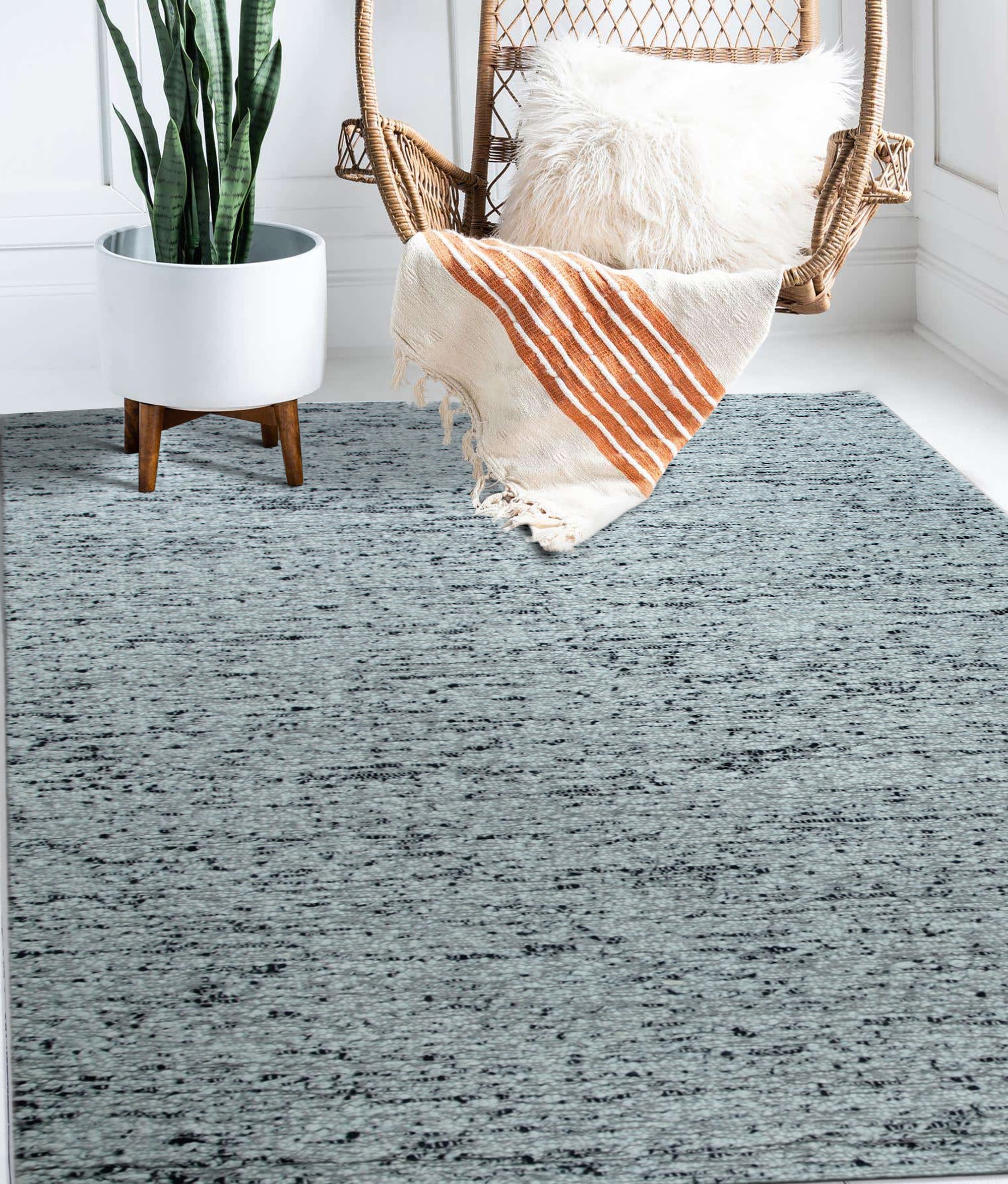 Opulent Alluring Dark Gray Handmade Wool Rug, its plush texture and subtle gray variations grounding a living space with modern elegance, seen in a styled interior shot.