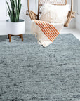 Opulent Alluring Dark Gray Handmade Wool Rug, its plush texture and subtle gray variations grounding a living space with modern elegance, seen in a styled interior shot.