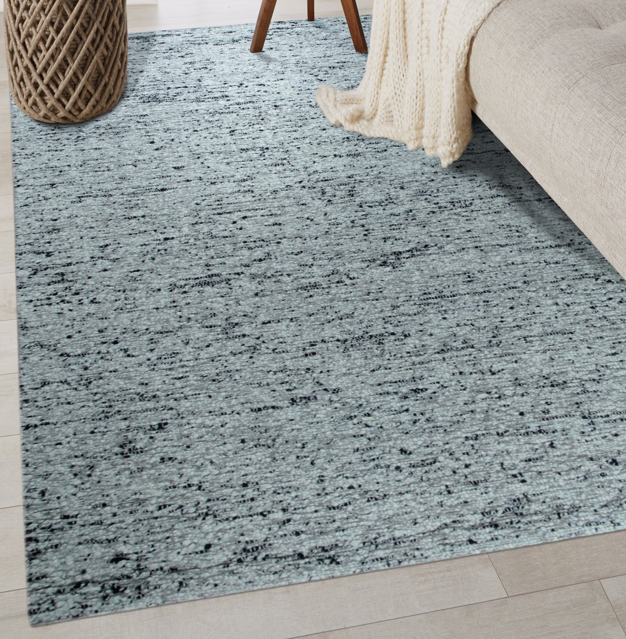 Opulent Alluring Dark Gray Handmade Wool Rug, its deep charcoal tones grounding a modern living space, woven texture inviting touch and warmth beneath elegantly placed furniture.