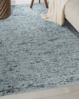Opulent Alluring Dark Gray Handmade Wool Rug, its deep charcoal tones grounding a modern living space, woven texture inviting touch and warmth beneath elegantly placed furniture.