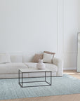 Opulent Alluring Silver Handmade Wool Rug, its shimmering silver tones and intricate hand-knotted details blending seamlessly into a modern living room setting.
