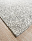 Opulent Alluring Silver Handmade Wool Rug, its shimmering silver tones and dense wool pile creating a luxurious and inviting texture on a light-toned floor.