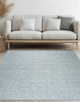 Opulent Alluring Silver Handmade Wool Rug, its subtle sheen catching the light in a bright, contemporary living room setting.