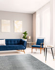 Tessa Maya Gray Hand Knotted Wool Rug graces a living room setting, its subtle gray tones complementing modern furniture and light hardwood floors.