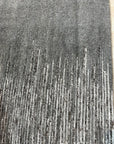 Tessa Maya Gray Hand Knotted Wool Rug, its subtle gray tones and hand-knotted texture enriching a modern living room setting with warm wood furniture and natural light.