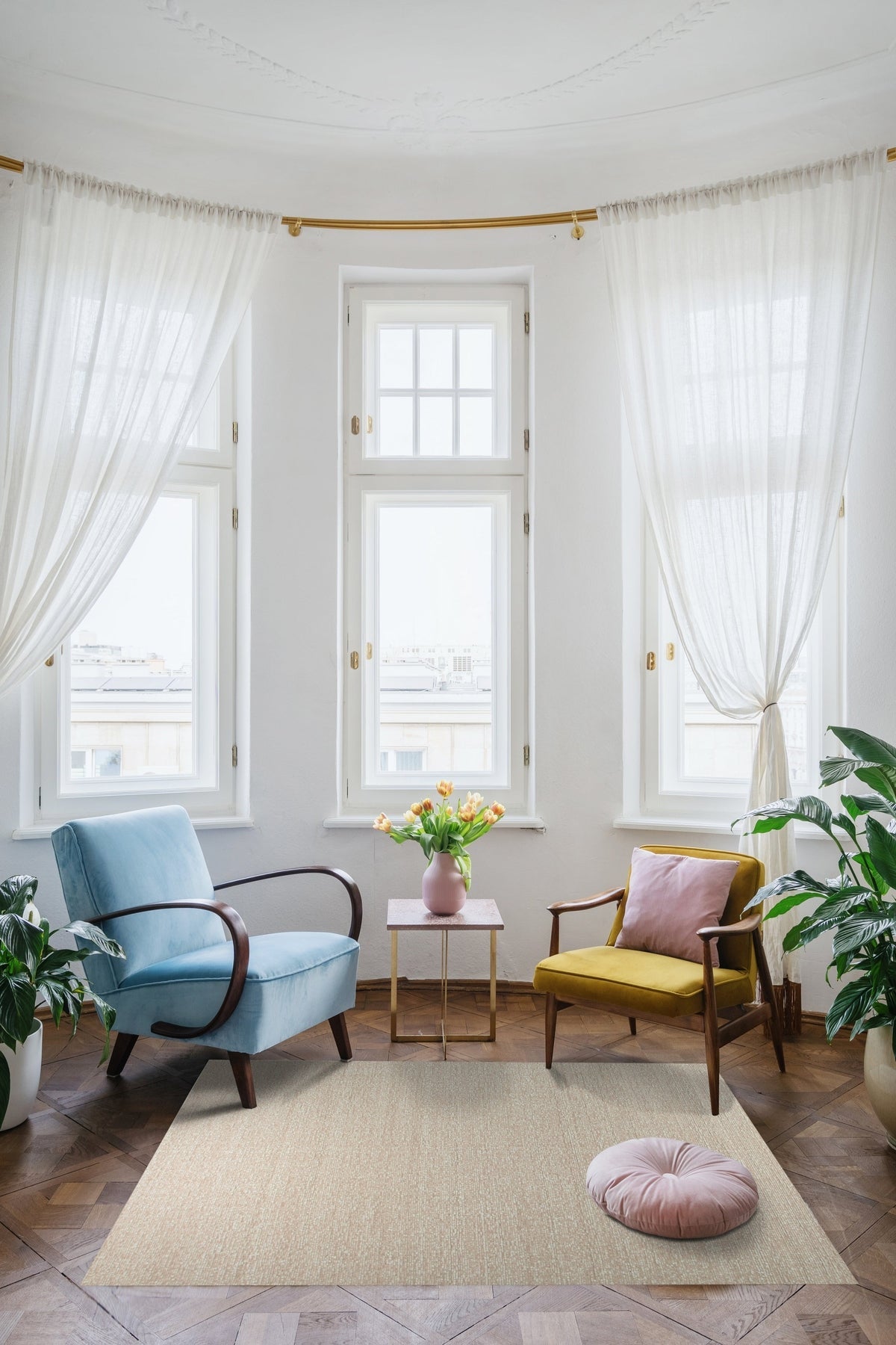 Freya Graceful Pink Handmade Wool Rug, a soft pink wool rug with subtle, abstract patterns, nestled in a cozy living room setting with a white sofa and natural light.