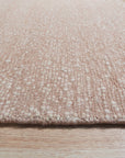 Freya Graceful Pink Handmade Wool Rug, softly lit detail highlighting its texture and the subtle variations in pink wool.