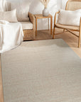 Freya Graceful Pink Handmade Wool Rug, a soft pink wool rug with subtle, flowing design, lending a touch of understated elegance to a bright, airy living space.