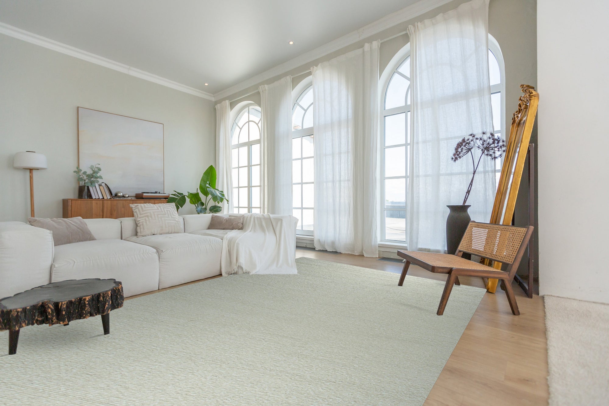 Bespoke Delicate Ivory Handmade Wool Rug displayed in a bright, minimalist living space, its soft ivory tones complementing the light hardwood flooring. The rug's subtle texture and handmade construction add warmth and sophistication to the room.