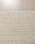 Bespoke Delicate Ivory Handmade Wool Rug, softly textured wool pile in warm ivory, inviting touch and subtle visual depth on a light hardwood floor.