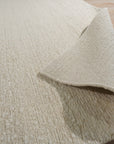 Bespoke Delicate Ivory Handmade Wool Rug, softly luminous in a bright, airy space. Hand-knotted wool pile radiates warmth with subtle textural variations. Ivory tones evoke understated elegance.
