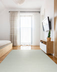 Bespoke Delicate Ivory Handmade Wool Rug, its plush ivory wool pile inviting touch and showcasing subtle texture variations across its handmade construction, displayed in a warmly lit, minimalist room.