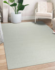 Bespoke Delicate Ivory Handmade Wool Rug, showcasing its texture and subtle variations in ivory tones, laid against a light surface, its handcrafted wool construction evident in the pile's soft appearance.