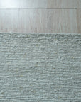 Fiona Rustic Ivory Flatweave Wool Rug, its soft ivory tones and flatweave construction complementing a bright living space with natural light and modern furniture.
