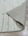 Para Vibrant White Hand Knotted Wool Rug, a creamy wool rug hand-knotted with a subtle, textural design, nestled within a bright and airy living space.
