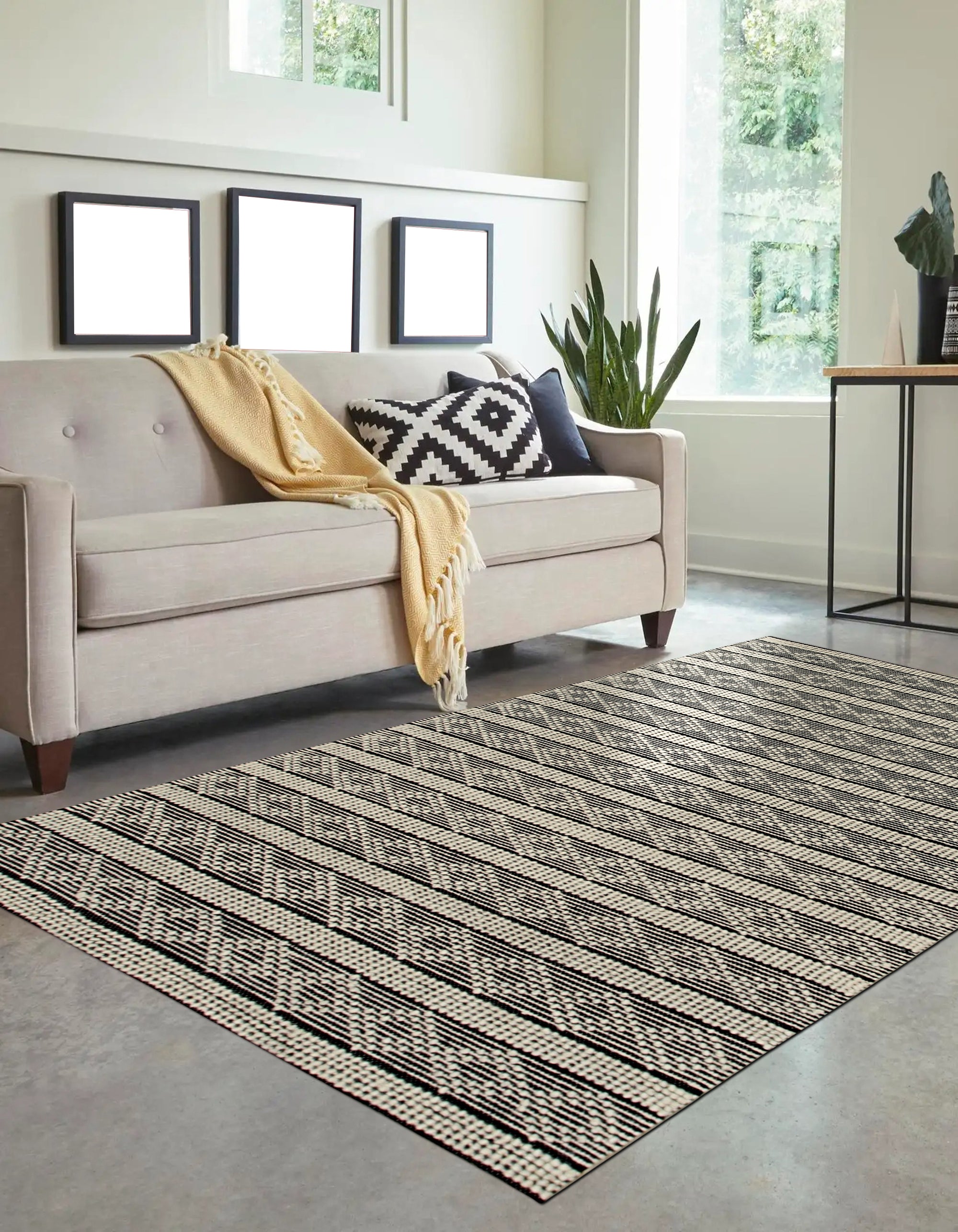 Selene Striped Black Handmade Wool Rug, a hand-woven wool rug with bold black and off-white stripes, adding a modern geometric touch to a minimalist living room.