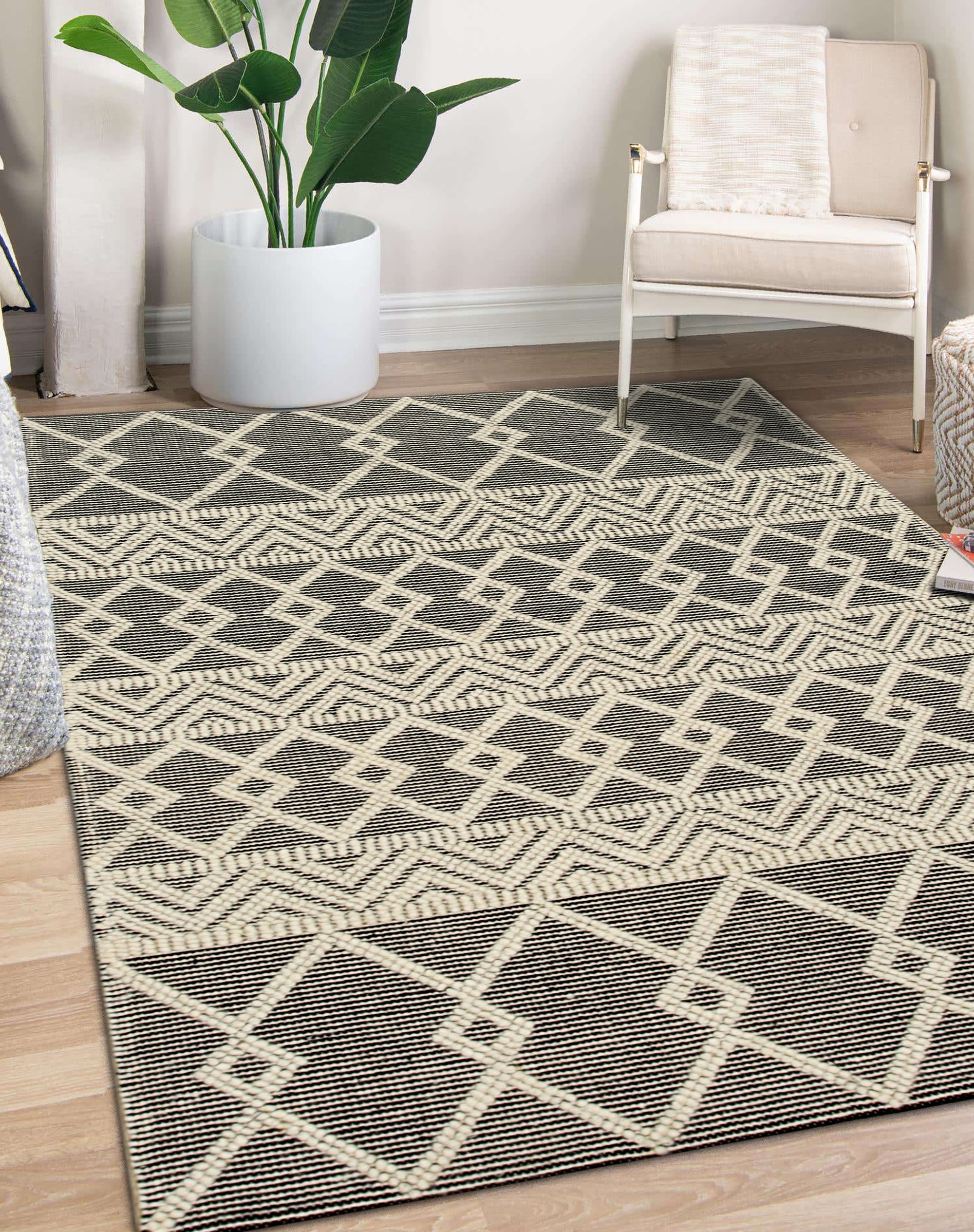 Modern Kilim Black Handmade Wool Rug, textured black wool rug with geometric kilim patterns, anchoring a minimalist living room with light wood floors and neutral furniture.