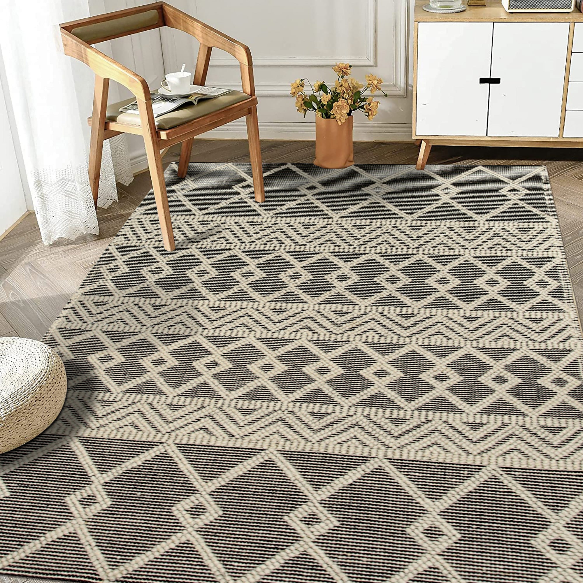 Modern Kilim Black Handmade Wool Rug, showcasing bold geometric patterns in stark black against a neutral backdrop, lending a contemporary touch to a bright, minimalist living space.