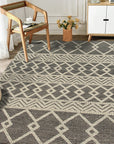 Modern Kilim Black Handmade Wool Rug, showcasing bold geometric patterns in stark black against a neutral backdrop, lending a contemporary touch to a bright, minimalist living space.