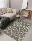 Luna Kilim Black Handmade Wool Rug, a geometric patterned flatweave adding a touch of modern tribal style to a bright, airy living room with hardwood floors.