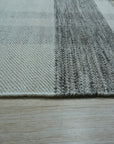 Giselle Serene Multicolor Flatweave Wool Rug, blending blues, oranges, creams, and browns in a modern geometric pattern on a light wood floor, showcasing its intricate flatweave construction and serene color palette.