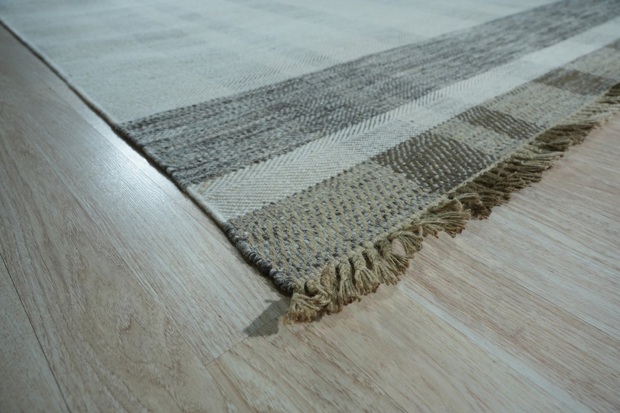 Giselle Serene Multicolor Flatweave Wool Rug displayed in a bright living space. The rug's flatweave construction showcases a serene blend of multiple colors, grounding the light-filled room.
